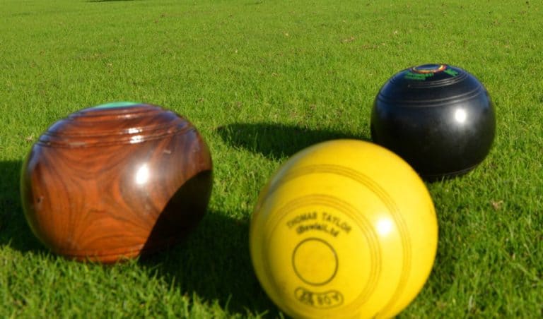 Kingsthorpe Bowling Club Blog page, header image of three bowls close together on an outdoor bowling green.