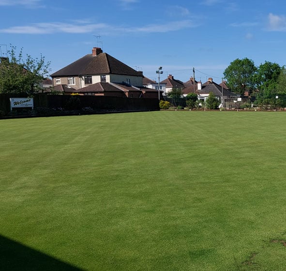 View of the outdoor lawn bowls green at Kingsthorpe Bowling Club. Picture taken from the clubhouse looking across the green to the main car park. entrance