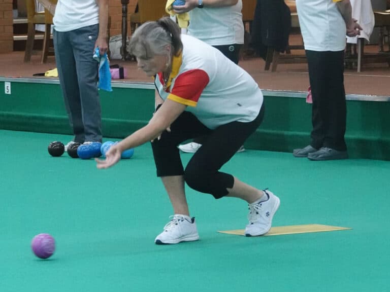 One of our lady members delivering a bowl in a match at Kingsthorpe Indoor Bowling Club